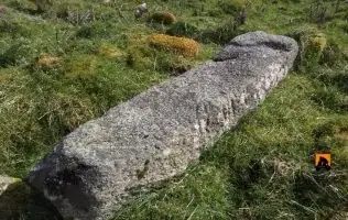 Kilgarvan Ogham stone lying flat in the graveyard, Co. Mayo