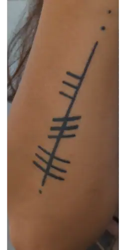 Ogham tattoo —  on arm