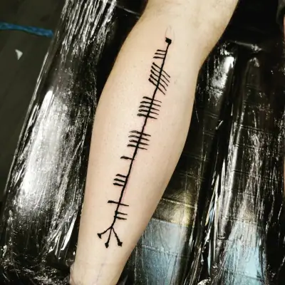 Ogham tattoo —  on leg