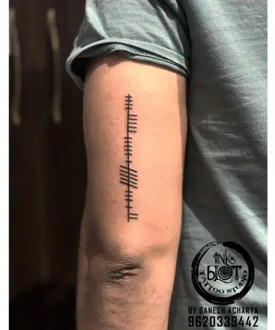 Ogham tattoo —  on arm